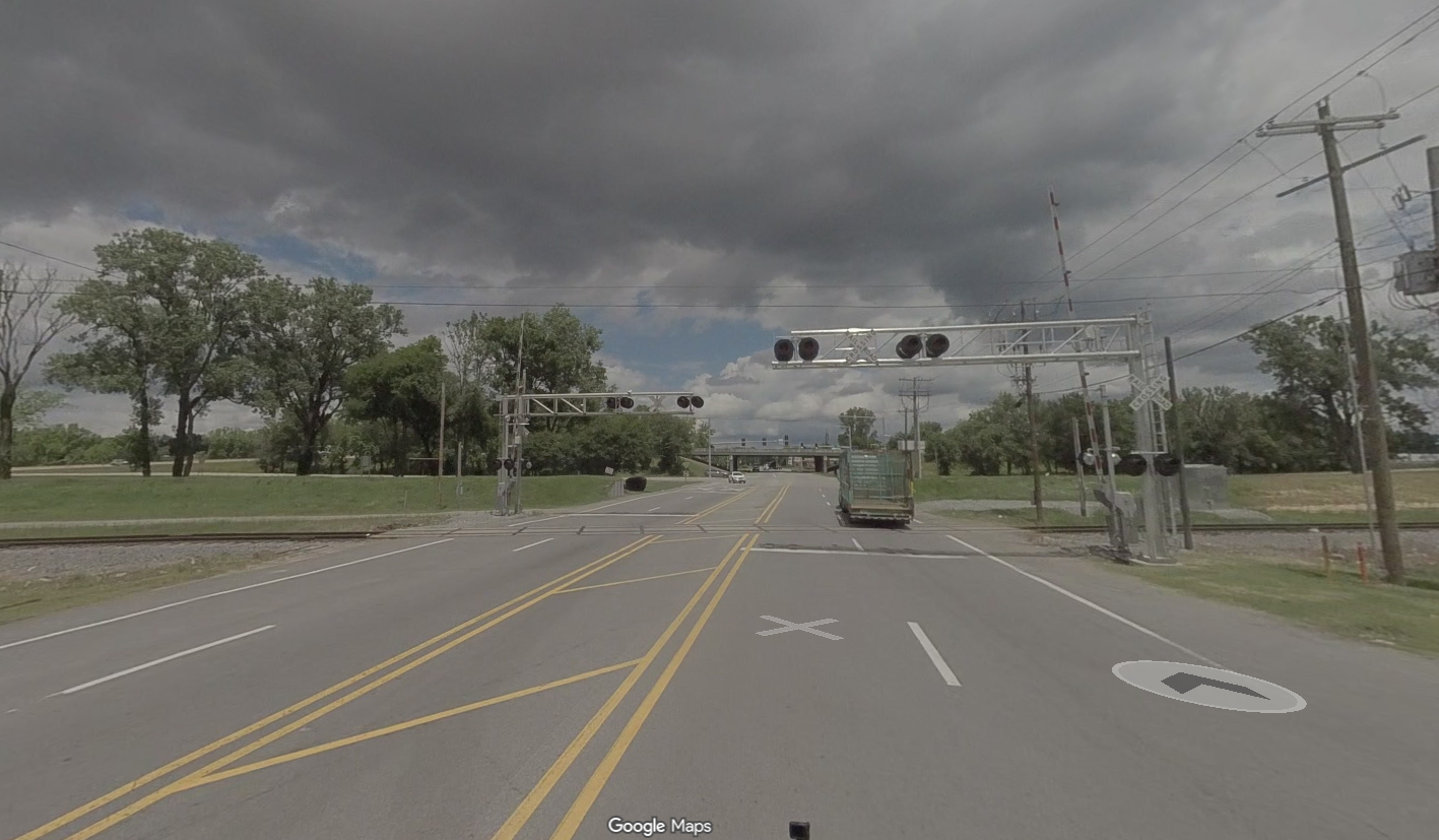 Image of the Fourche Dam Pike railroad crossing facing north towards I440